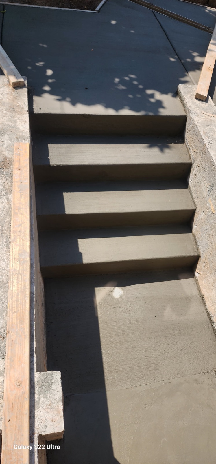 Team pouring concrete patio
